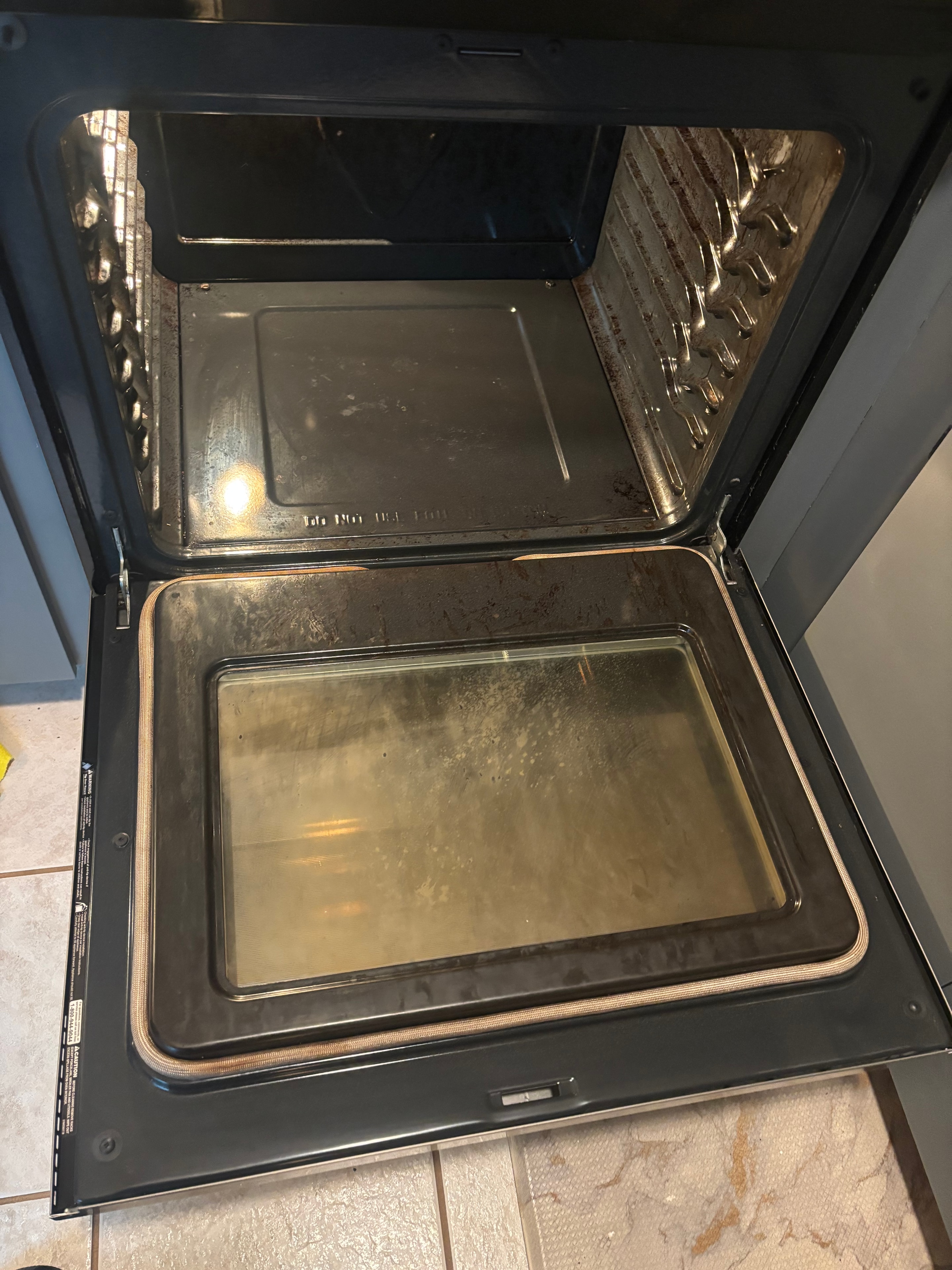 Oven ceiling with baked-on grease before cleaning